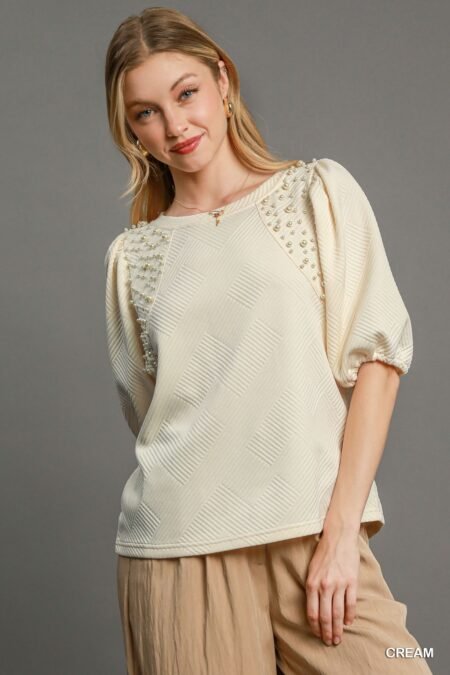 Puff Sleeve Knit Top in Cream, featuring soft knit jacquard fabric, dramatic puff sleeves, and elegant pearl details for a sophisticated look