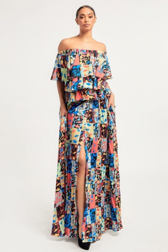 Printed ruffle top and pleated skirt set in orange with adjustable styling options and functional pockets.