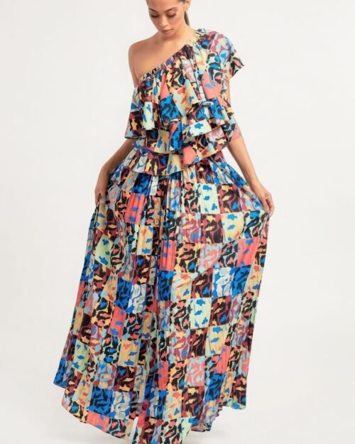 printed ruffle top and pleated skirt set in orange with adjustable styling options and functional pockets.