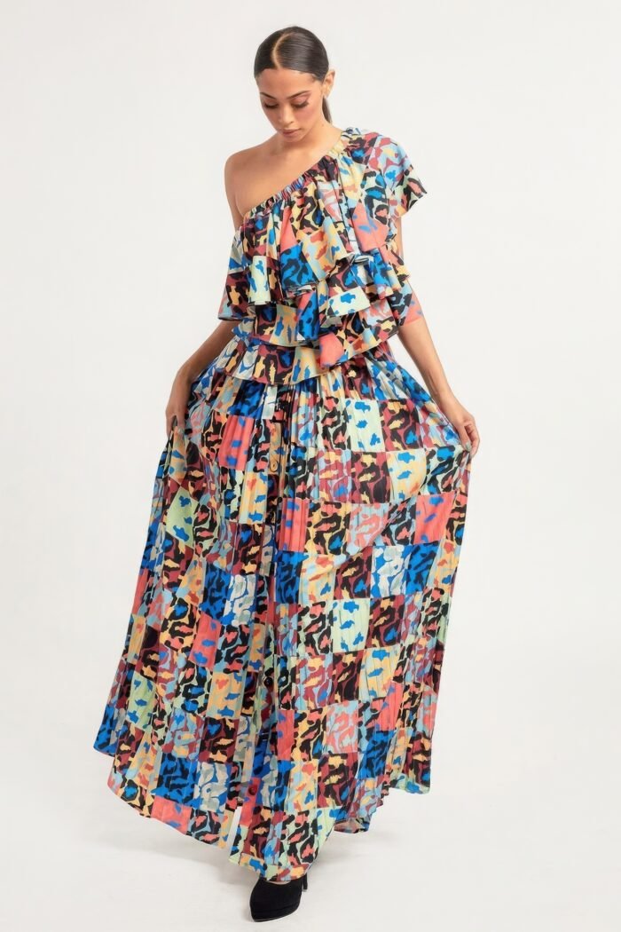 Printed ruffle top and pleated skirt set in orange with adjustable styling options and functional pockets.