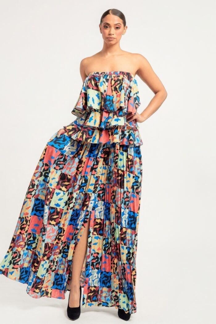 Printed ruffle top and pleated skirt set in orange with adjustable styling options and functional pockets.