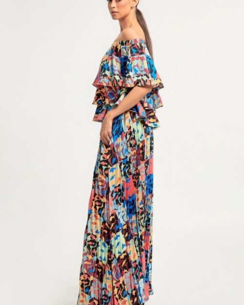 printed ruffle top and pleated skirt set in orange with adjustable styling options and functional pockets.