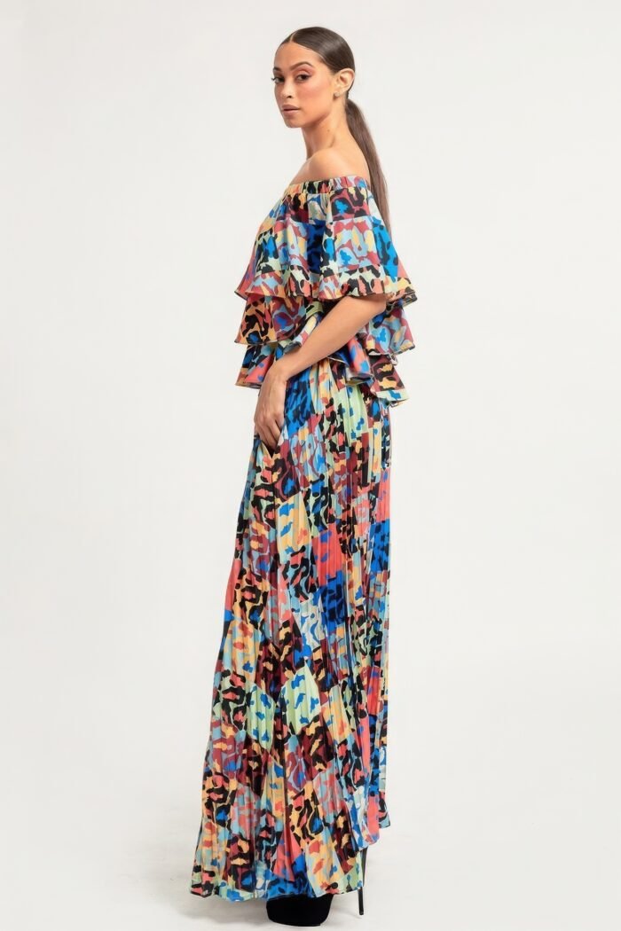 Printed ruffle top and pleated skirt set in orange with adjustable styling options and functional pockets.