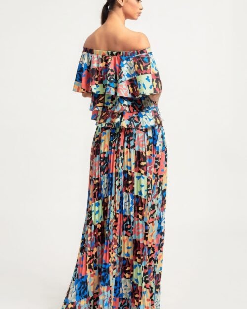 printed ruffle top and pleated skirt set in orange with adjustable styling options and functional pockets.