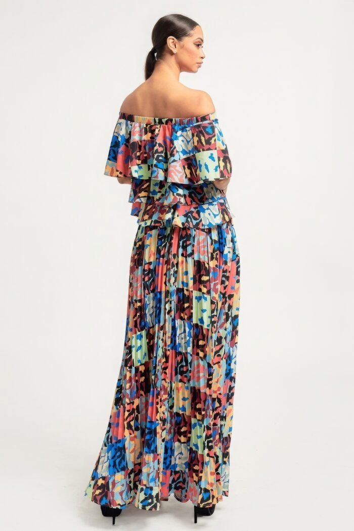 Printed ruffle top and pleated skirt set in orange with adjustable styling options and functional pockets.
