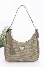 Faux leather shoulder bag in black with woven design and triangle handle – vegan handbag