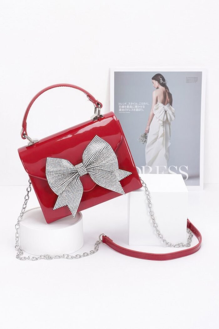 Enamel rhinestone ribbon top handle clutch