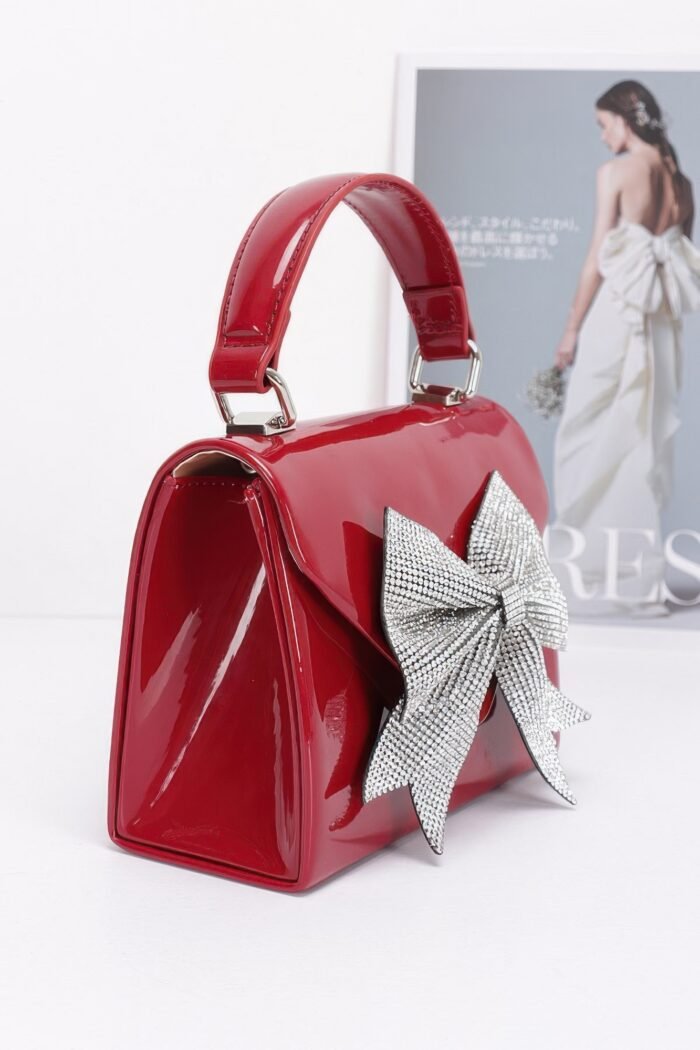 Enamel rhinestone ribbon top handle clutch