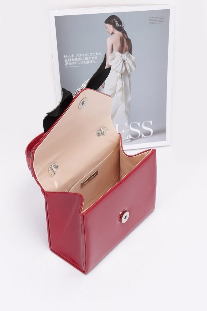 Enamel rhinestone ribbon top handle clutch