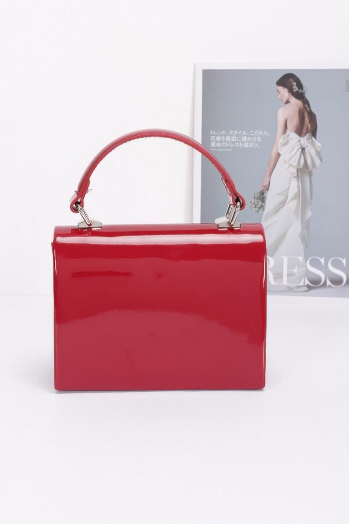 Enamel rhinestone ribbon top handle clutch