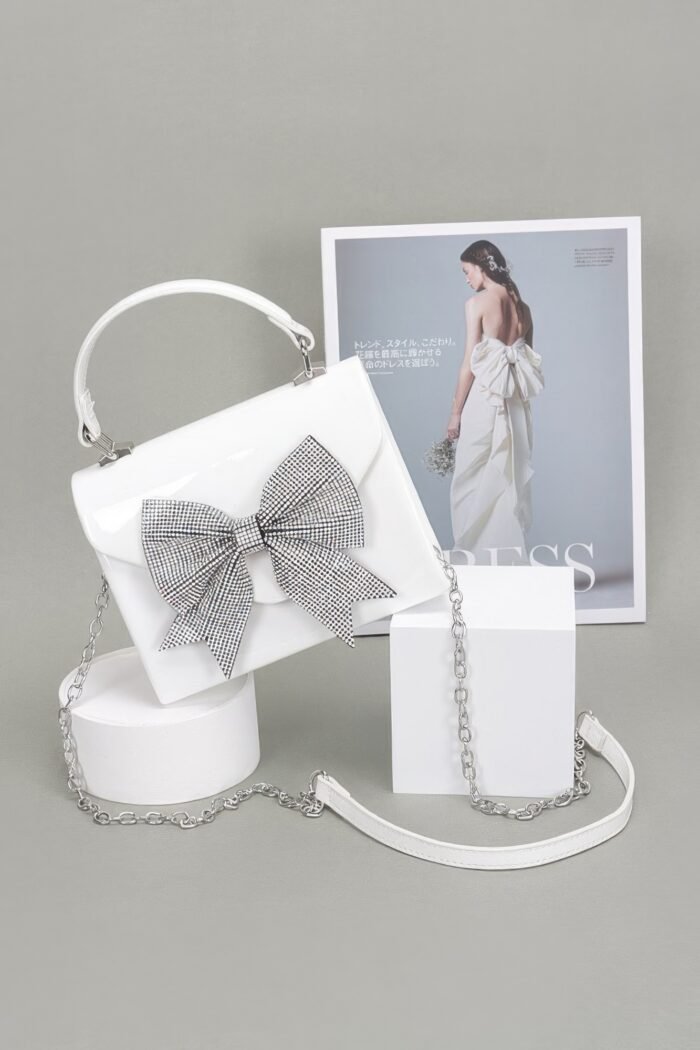 Enamel rhinestone ribbon top handle clutch