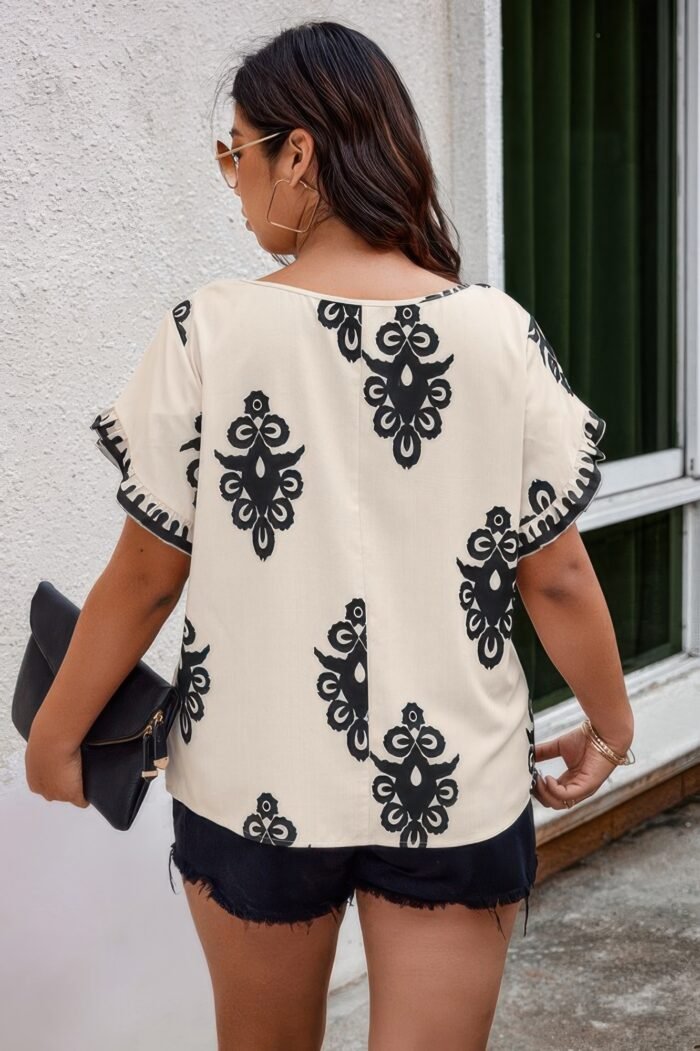 Plus printed ruffle hem wide round neck blouse