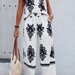Woman wearing floral sleeveless two piece set – knot shoulder top and elastic waist pants, perfect for warm weather