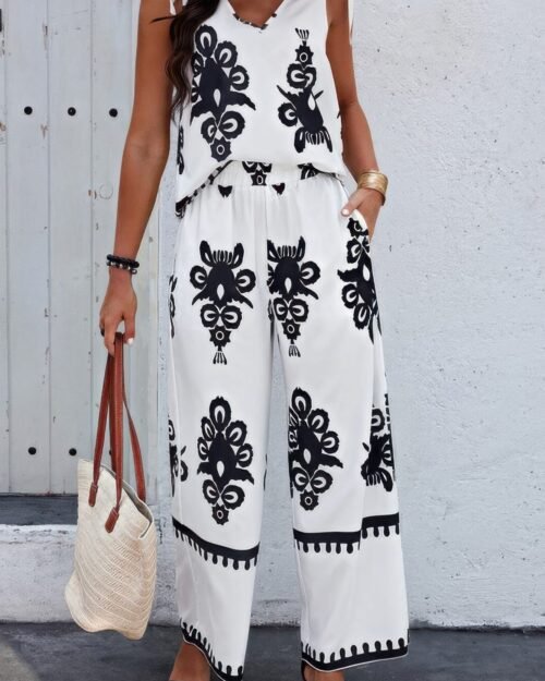 Woman wearing floral sleeveless two piece set – knot shoulder top and elastic waist pants, perfect for warm weather