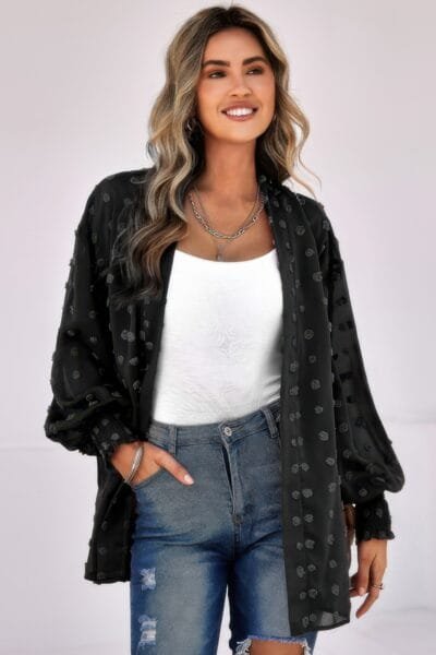 Woman wearing polka dot open front top – long sleeve, lightweight casual blouse with front tie or button design