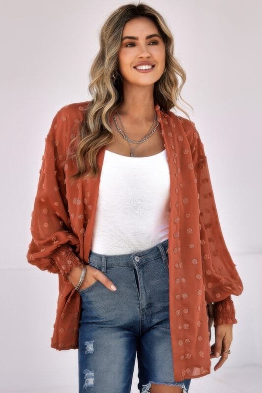 Woman wearing polka dot open front top – long sleeve, lightweight casual blouse with front tie or button design