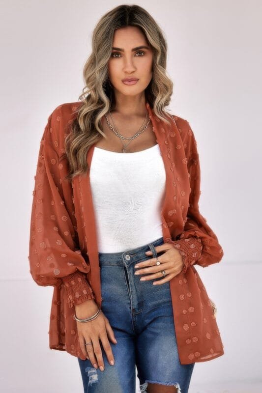 Woman wearing polka dot open front top – long sleeve, lightweight casual blouse with front tie or button design