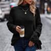 Woman wearing loose turtleneck sweater – long sleeve, solid knit acrylic pullover in olive and black