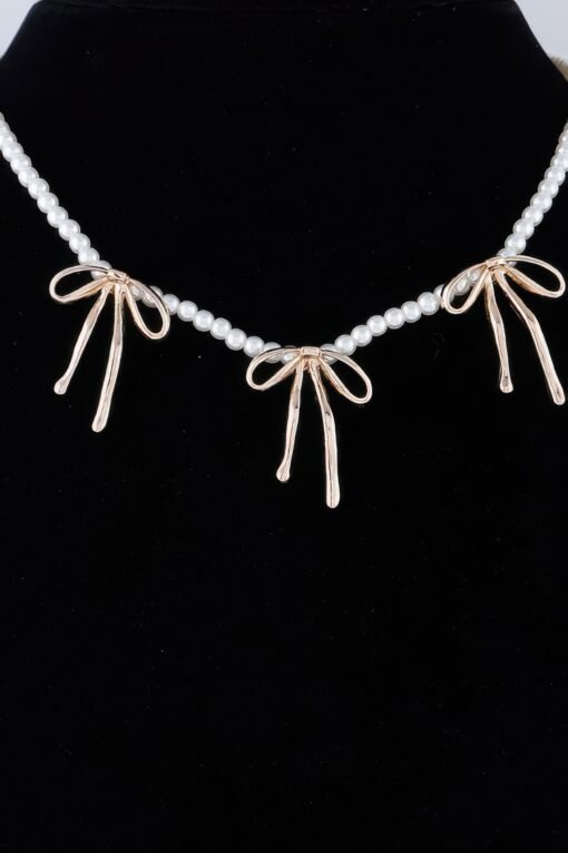 Pearl And Metal Ribbon Charm Necklace