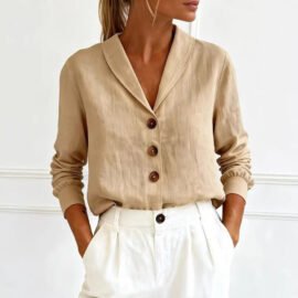 Front view of a woman wearing a neutral beige Linen Look Shawl Collar Blouse tucked into white tailored trousers