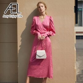 Front view of woman wearing Lavender Violet Leopard Jacquard Satin Maxi Wrap Dress with pink handbag